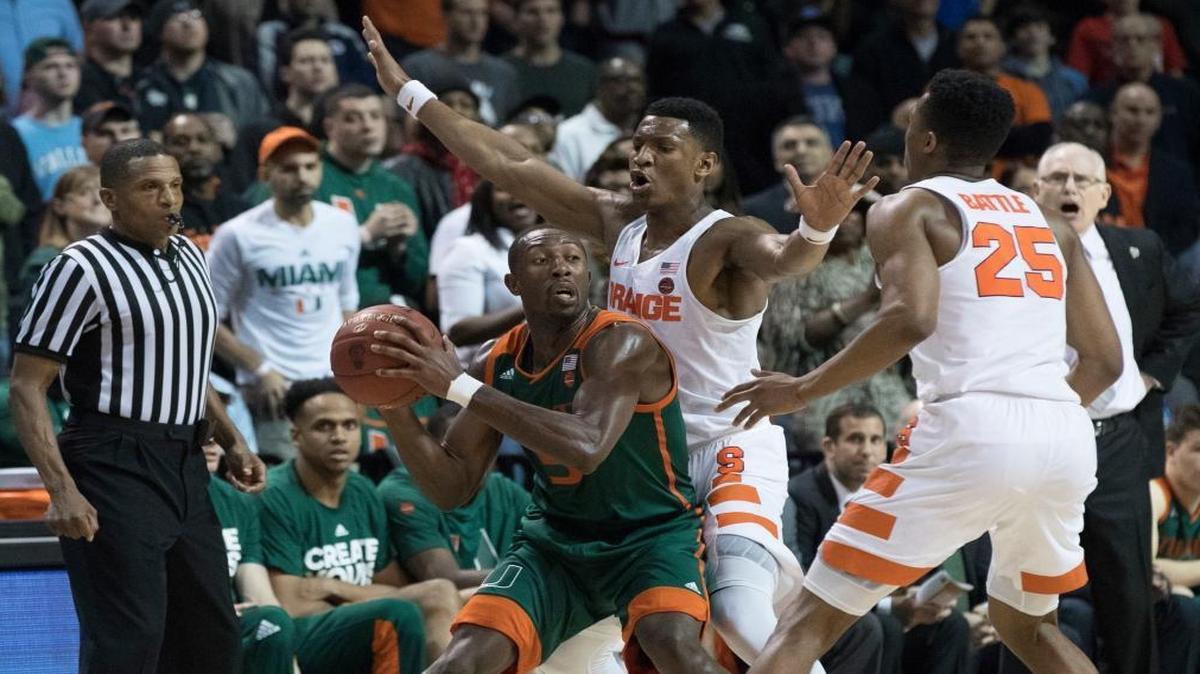 Syracuse guard Tyus Battle (25) and guard Andrew White III, second from right, guard Miami guard Davon Reed (5) during the second half of an NCAA college basketball game in the Atlantic Coast Conference tournament, Wed., March 8, 2017, in New York. Miami won 62-57.