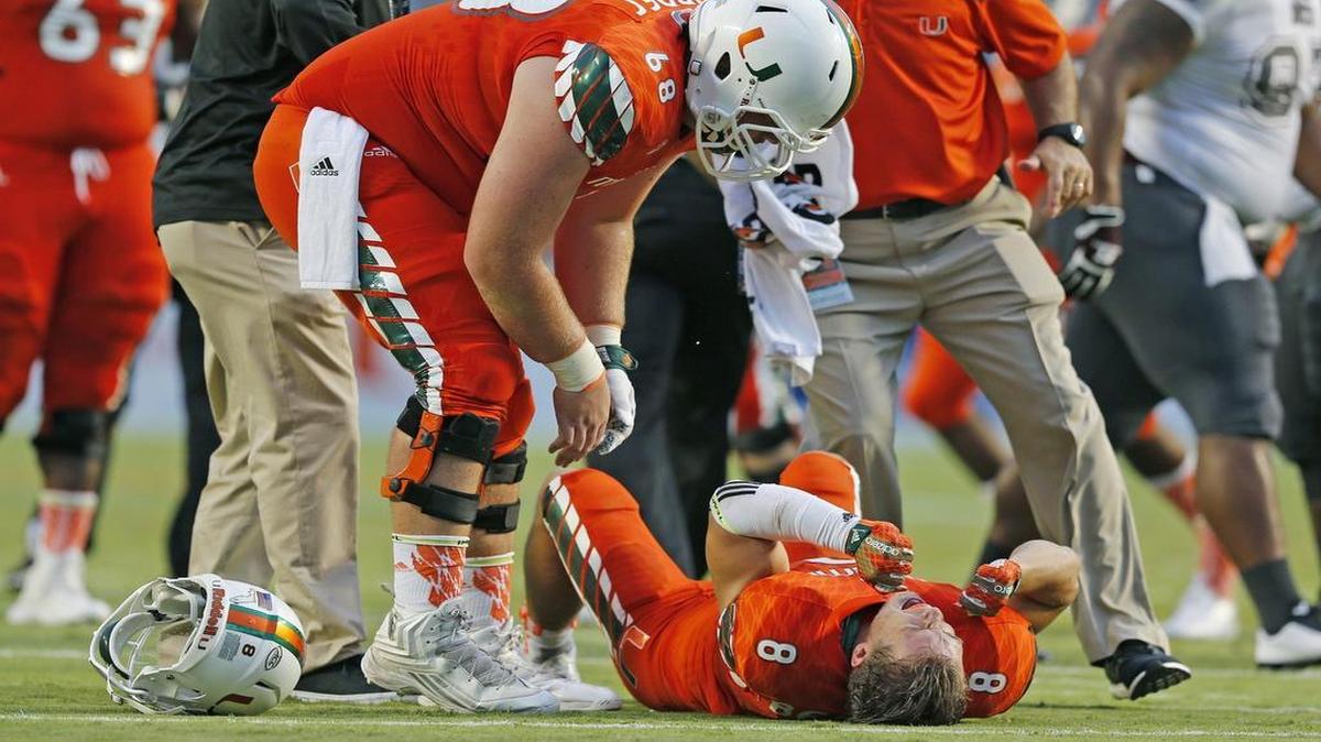 
Miami Hurricanes wide receiver Braxton Berrios (8) grimaces in pain after going down in the first quarter as the University of Miami hosts Bethune Cookman at Sun Life Stadium on Saturday, September 5, 2015.
