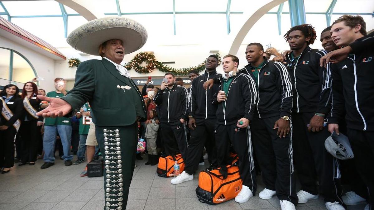 Henry Lopez serenades the Miami football team after it arrived at El Paso International Airport on Monday, Dec. 21, 2015, in El Paso, Texas. Miami faces Washington State in the Sun Bowl on Saturday.