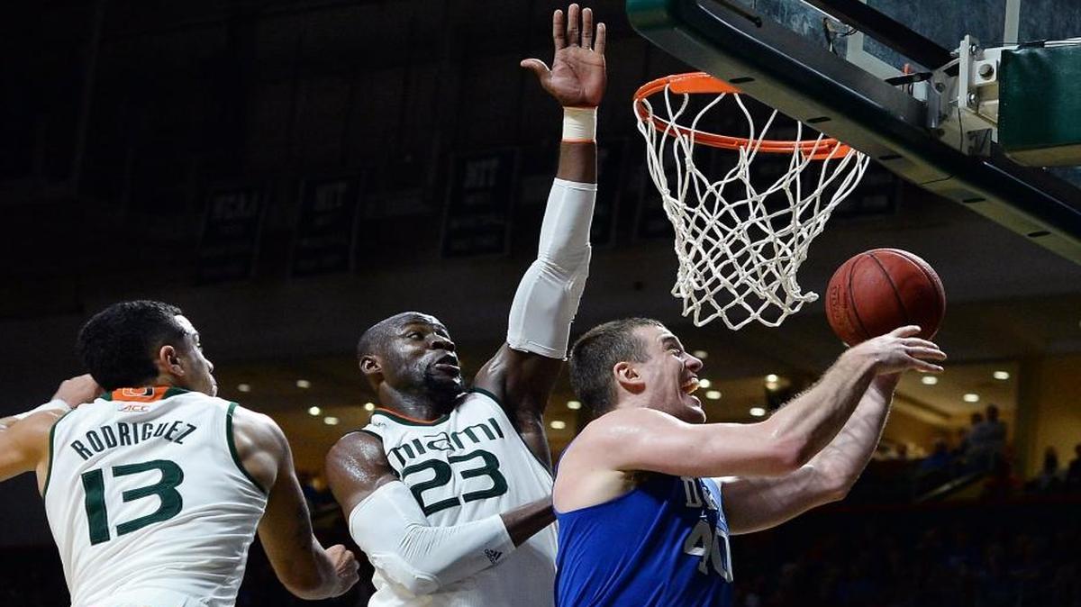 Duke center Marshall Plumlee goes to the basket against UM center Tonye Jekiri (23) and guard Angel Rodriguez (13) during the second half Monday, Jan. 25, 2016 at BankUnited Center in Coral Gables.