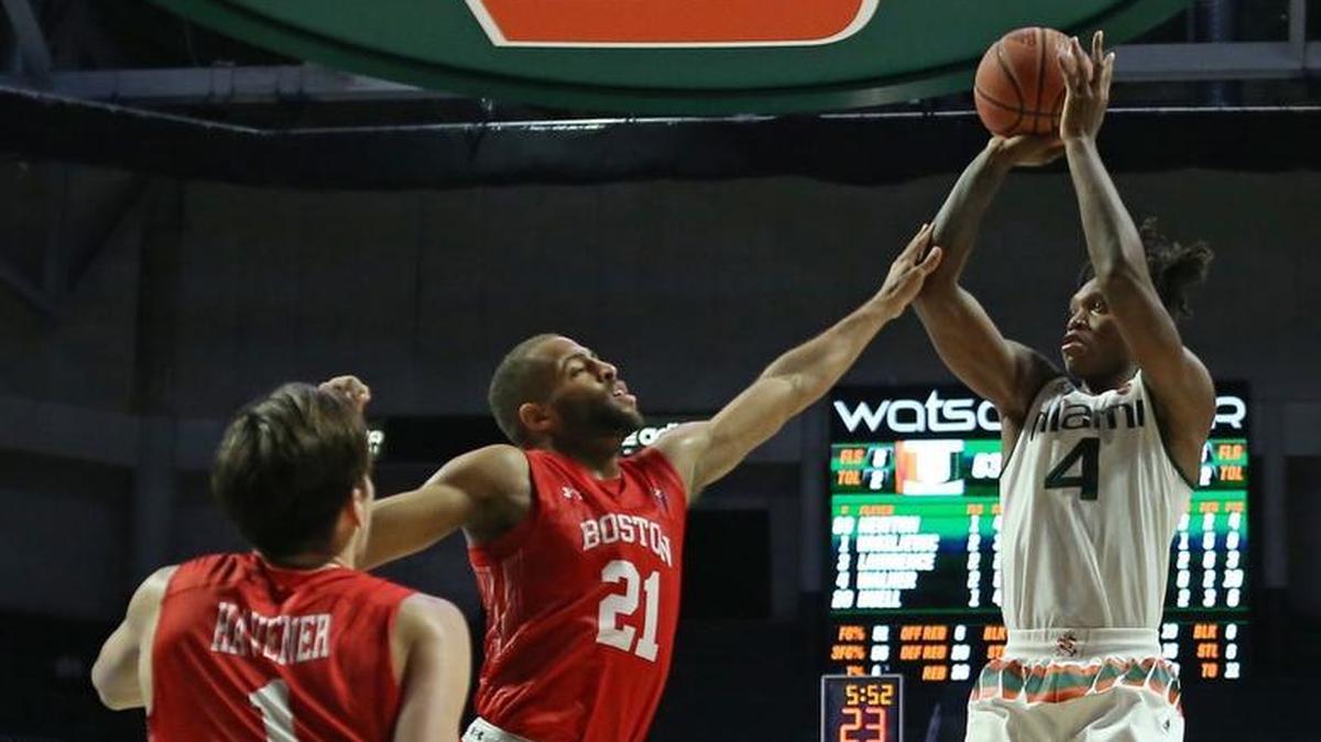 Miami Hurricanes guard Lonnie Walker IV goes to the basket against Boston University Terriers guard Cedric Hankerson #21 during the second half of an NCAA college basketball game at the Watsco Center in Coral Gables on Tuesday, Dec. 5, 2017.