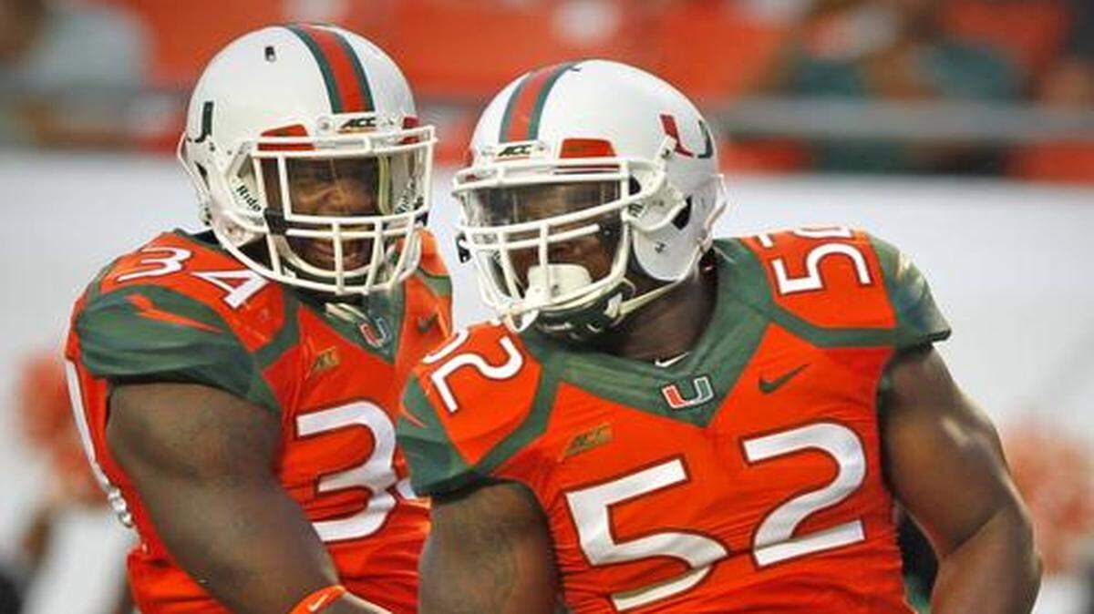 
Tough road: Hurricanes linebacker Denzel Perryman (52), with Thurston Armbrister, relishes the challenge of playing in Lincoln, Nebraska, on Saturday. ‘I can’t wait for this matchup.’
