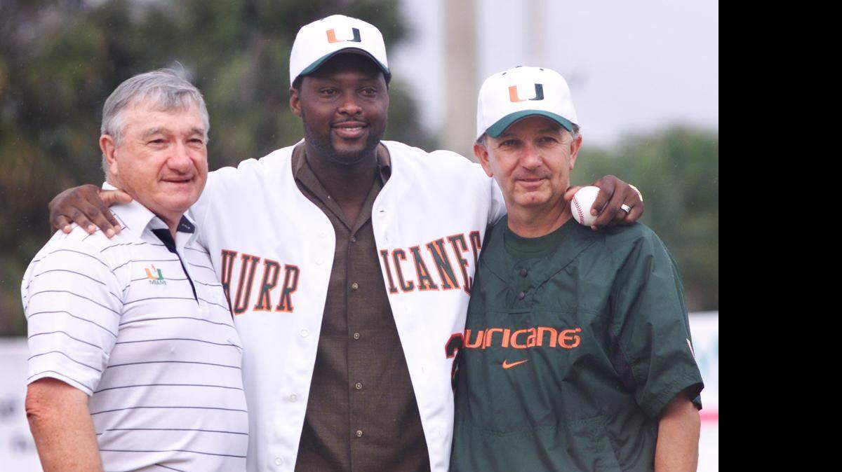 
Then-Miami Marlins catcher and UM alum Charles Johnson, center, poses with former UM baseball coach Ron Fraser, left, and current coach Jim Morris during a ceremony retiring Johnson’s UM jersey on Feb. 10, 2002.


