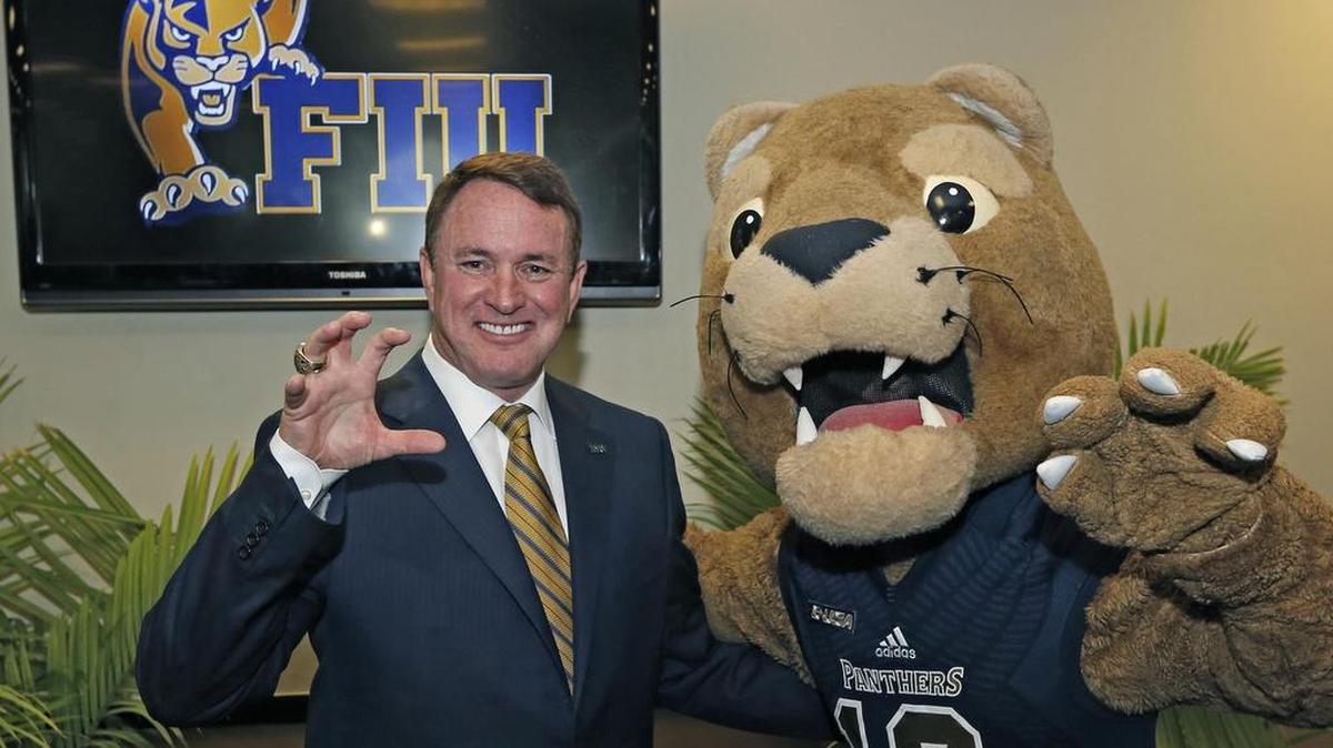Butch Davis poses with the FIU mascot after being named the Panthers’ new head football coach on Tuesday.