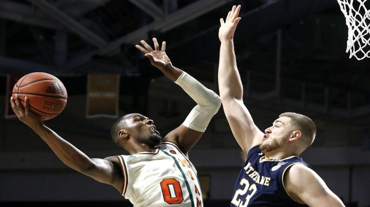Miami (FL) Hurricanes guard Ja'Quan Newton (0) shoots as Notre Dame Fighting Irish forward Martinas Geben (23) defends as the University of Miami hosts Notre Dame at the Watsco Center in Coral Gables on Thurs., Jan. 12, 2017.