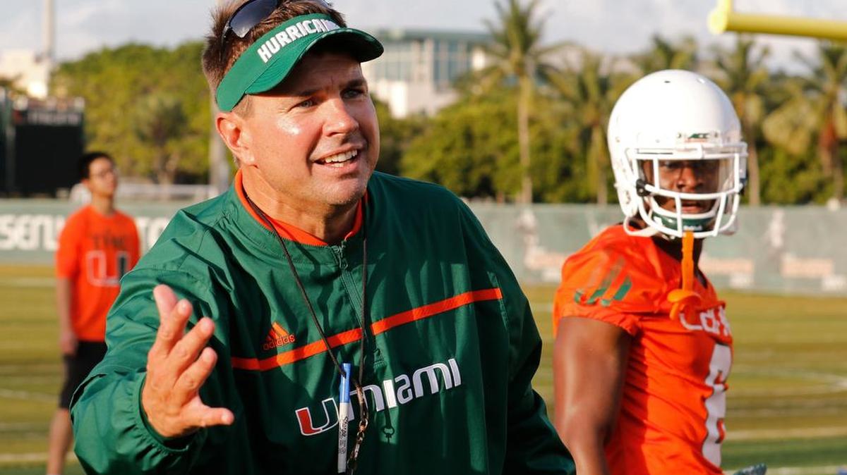 
UM coach Al Golden works with his players during fall camp practice Friday, Aug. 7, 2015, in Coral Gables. 
