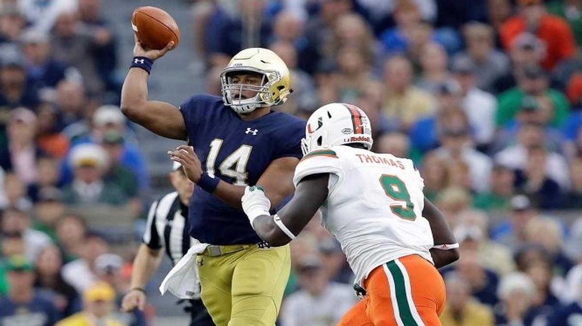 Notre Dame quarterback DeShone Kizer throws while being pursued by Miami 's Chad Thomas during the second half of an NCAA college football game Saturday, Oct. 29, 2016, in South Bend, Ind.