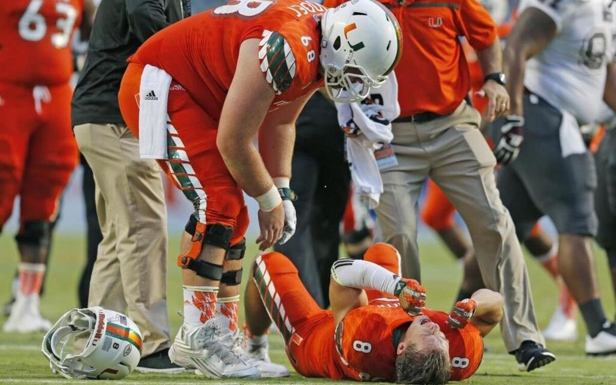 
Miami Hurricanes wide receiver Braxton Berrios (8) grimaces in pain after going down in the first quarter as the University of Miami hosts Bethune Cookman at Sun Life Stadium on Saturday, September 5, 2015.

