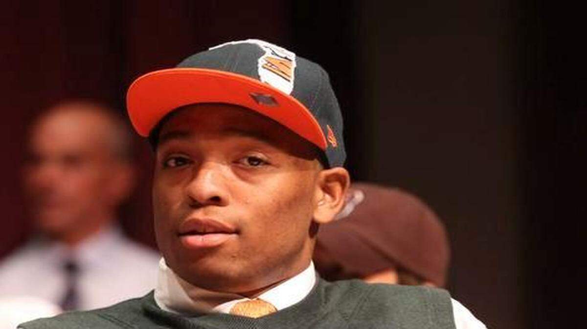 
St. Thomas Aquinas football player Jelani Hamilton gives a UM sign after he signed with the University of Miami, Wednesday, February 1, 2012.
