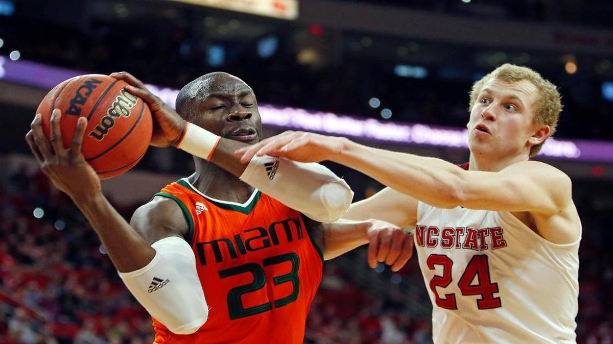North Carolina State's Maverick Rowan (24) battles Miami's Tonye Jekiri (23) for a rebound during the second half of an NCAA college basketball game in Raleigh, N.C., Saturday, Jan. 30, 2016. N.C. State won 85-69.