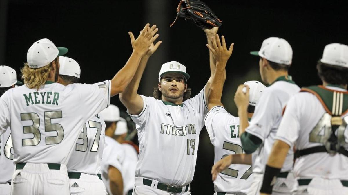 The closer, Miami pitcher Bryan Garcia (19) celebrates with teammates after the University of Miami defeats Stetson 4-2 at Alex Rodriguez Park in the NCAA Baseball Championship Coral Gables Regional on Fri., June 3, 2016.