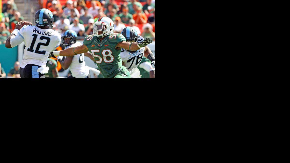 
Miami Hurricanes’ Darrion Owens chases down North Carolina quarterback Marquise Williams in the fourth quarter at Sun Life Stadium in Miami Gardens, Florida, on Sunday, Nov. 1, 2014.
