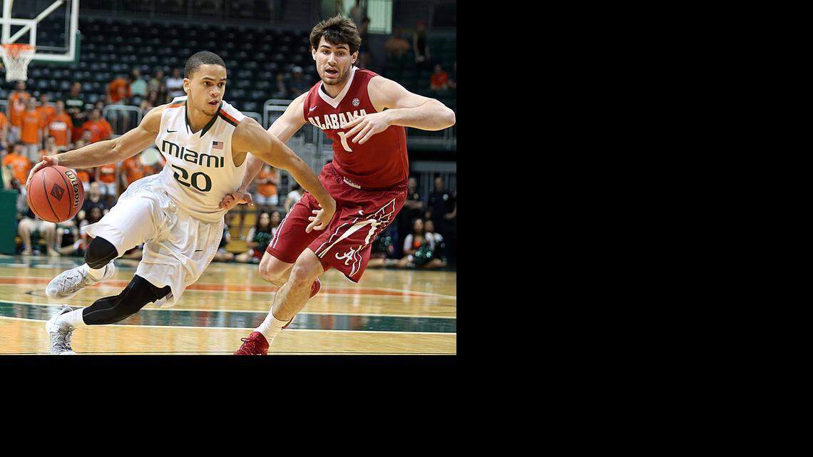 
UM guard Manu Lecomte drives past Alabama’s Riley Norris at BankUnited Center on Saturday, March 21, 2015.
