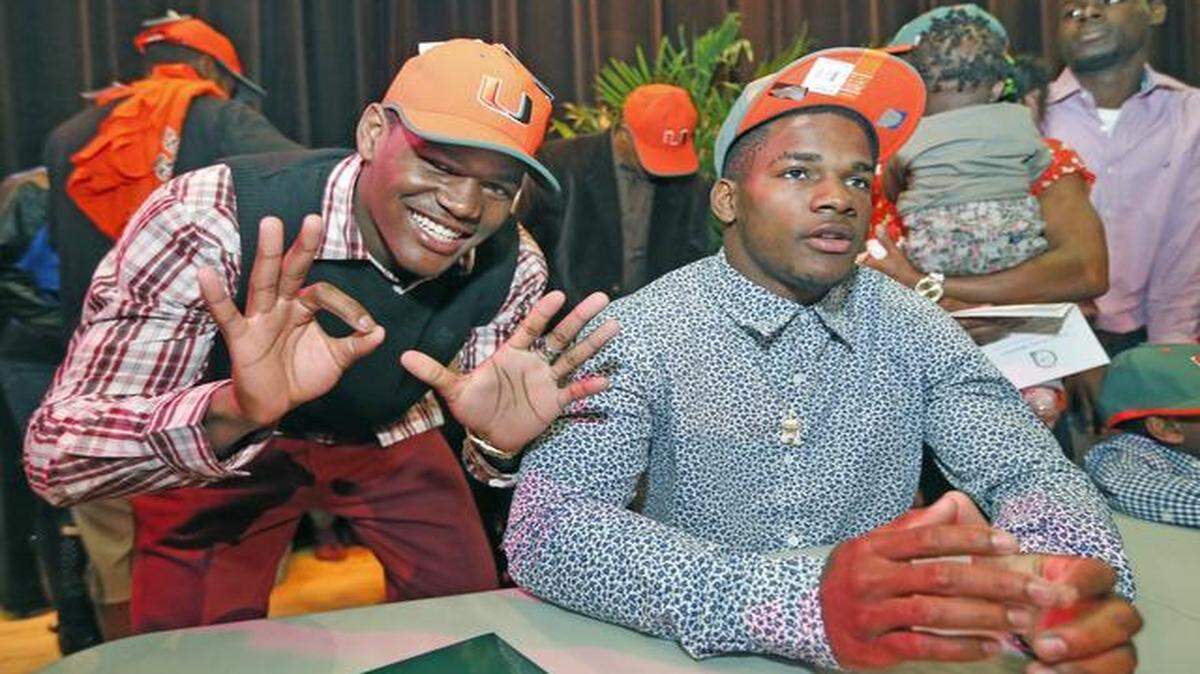 
James King and Mark Walton celebrate after signing with the University of Miami during National Signing Day at Booker T. Washington High School in Miami on Feb. 4, 2015.
