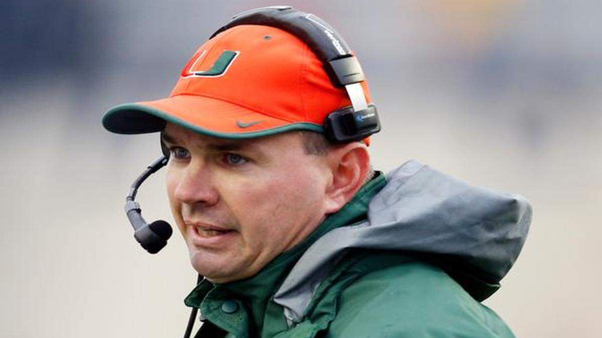 
Miami football coach Al Golden speaks into his headset in the second half of the Independence Bowl NCAA college football game against South Carolina in Shreveport, La., Saturday, Dec. 27, 2014. South Carolina won 24-21. 

