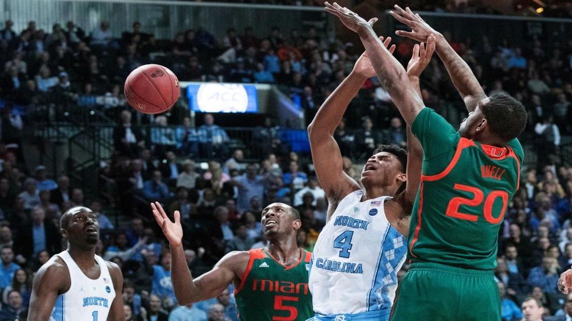 Miami forward Dewan Huell (20) blocks North Carolina forward Isaiah Hicks (4) from scoring during the second half of an NCAA college basketball game in the Atlantic Coast Conference tournament, Thurs., March 9, 2017, in New York. North Carolina won 78-53.
