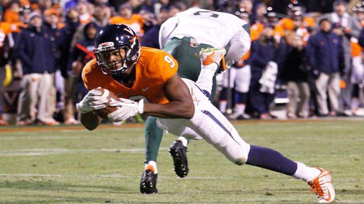 
Virginia wide receiver Canaan Severin (9) dives into the end zone for a touchdown during the second quarter of an NCAA college football game against Miami, Saturday, Nov. 22, 2014, in Charlottesville, Va. 
