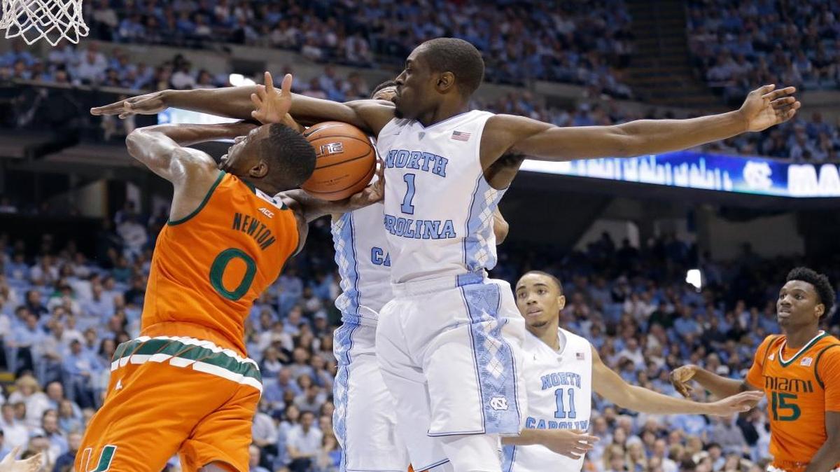 North Carolina's Theo Pinson (1) blocks Miami's Ja'Quan Newton (0) during the second half of an NCAA college basketball game in Chapel Hill, N.C., Saturday, Feb. 20, 2016. North Carolina won 96-71.