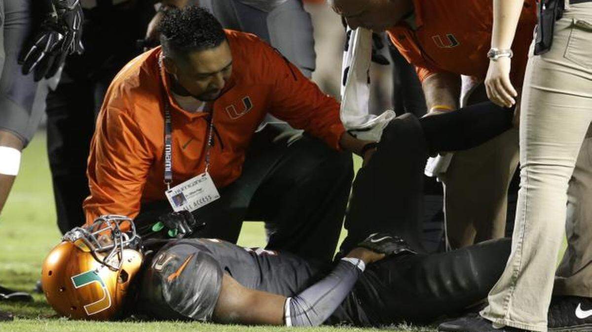 
UM safety Deon Bush is attended to by trainers after sustaining a hamstring injury against FSU on Saturday, Nov. 15, 2014, in Miami Gardens, Fla. 
