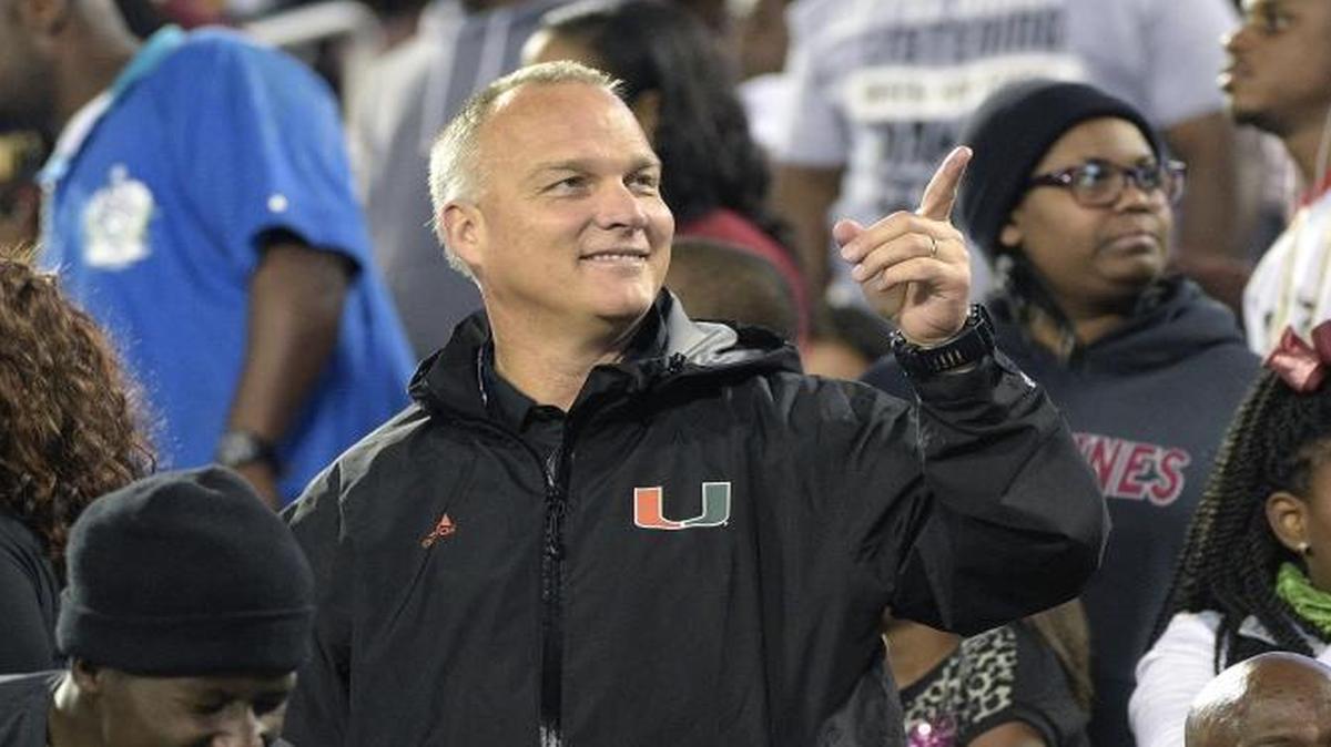 UM head coach Mark Richt, center, watches from the stands during the second half of a high school football championship game between Jacksonville Raines and Booker T. Washington in Orlando, Fla., Saturday, Dec. 5, 2015.
