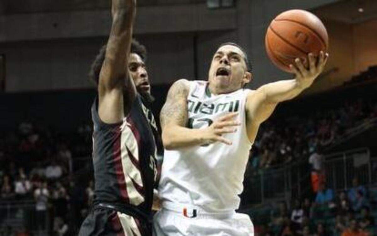 
UM guard Angel Rodriguez drives past FSU forward Phil Cofer for a layup in the first half at BankUnited Center in Coral Gables on Wednesday, Feb. 25, 2015. 
