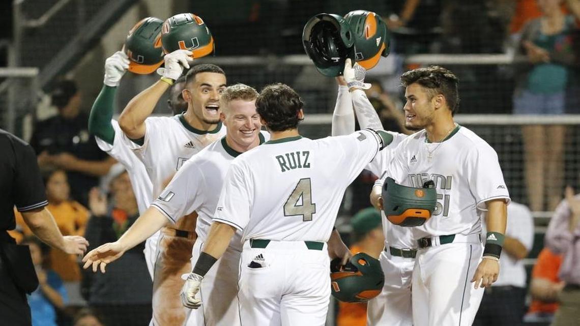 Miami infielder John Ruiz is greeted at home plate by teammates after hitting a grand slam in the eighth inning as the University of Miami hosts Boston College for NCAA Coral Gables Super Regional baseball series at Alex Rodriguez Park at Mark Light Field on Fri., June 10, 2016
