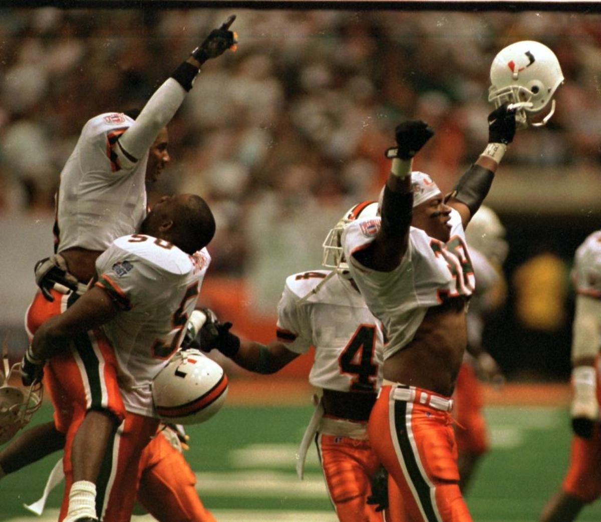 Miami Hurricanes Chad Wilson, Baraka Short, Earl Little and Malcolm Pearson celebrate a Miami win at the Syracuse Carrier Dome in 1994.