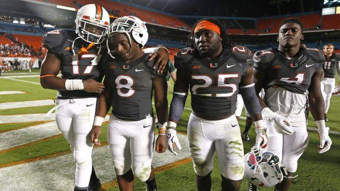 
Miami Hurricanes wide receiver D'Mauri Jones (17), running back Duke Johnson (8) defensive back Dallas Crawford (25) and wide receiver Phillip Dorsett (4) walk off the field after UM’s game against Pittsburgh at Sun Life Stadium on Saturday, November 29, 2014.
