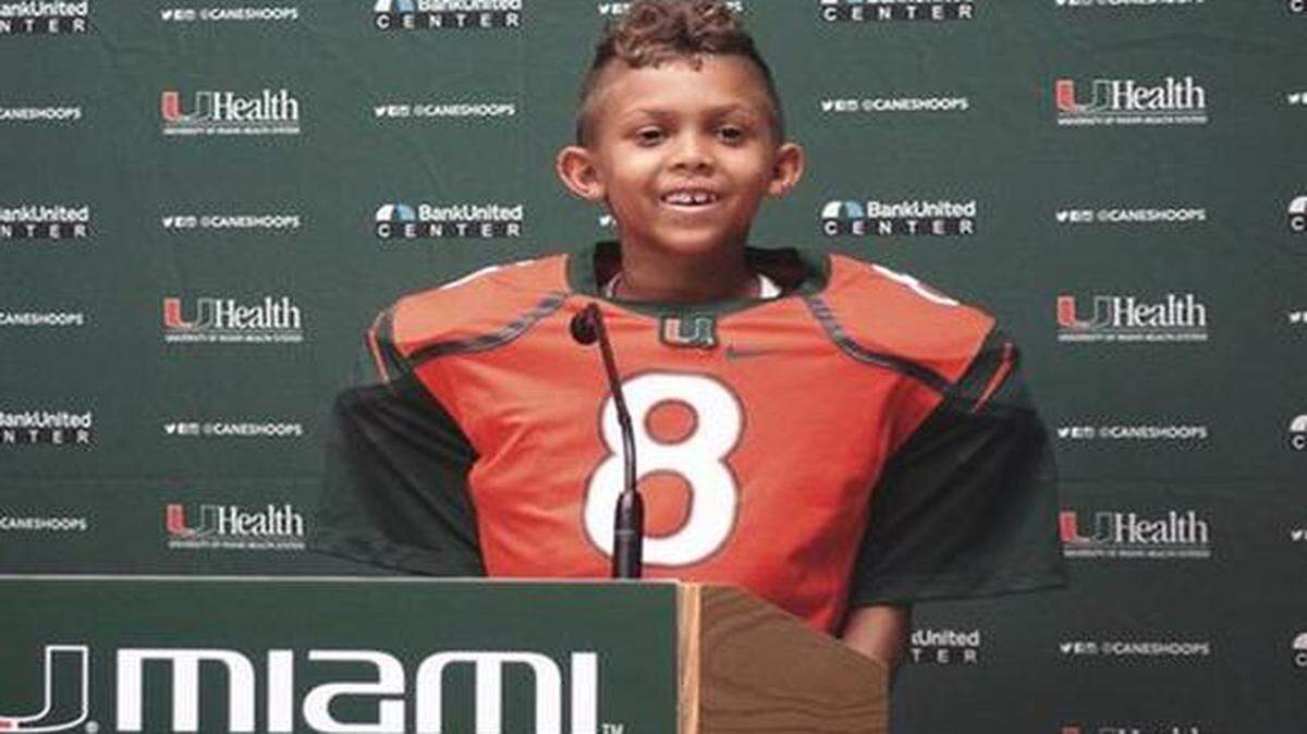 
Make-A-Wish kid Carter Hucks, who is scheduled to have a bone marrow transplant, received a game ball from UM running back Duke Johnson on Saturday, Oct. 11, 2014.

