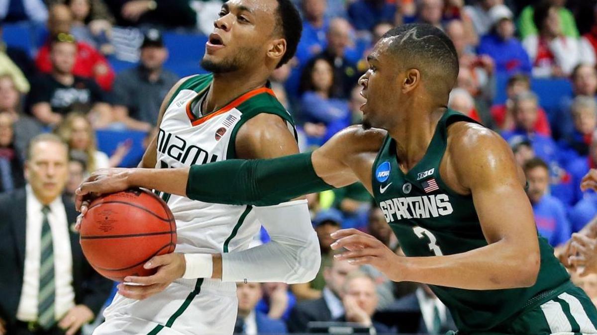 Miami guard Ja'Quan Newton, left, works to get a shot off against Michigan State guard Alvin Ellis III (3) in the first half of a first-round game in the men's NCAA college basketball tournament in Tulsa, Okla., Fri. March 17, 2017.