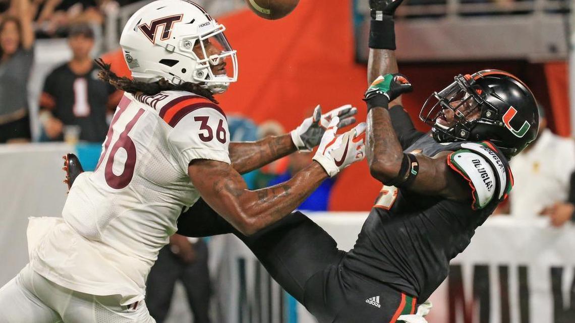 Miami Hurricanes wide receiver Jeff Thomas (4) can't get a handle on the ball as Virginia Tech Hokies cornerback Adonis Alexander (36) defends in a game last November. The Dolphins have interviewed Alexander, who is available in the July 11 NFL supplemental draft.