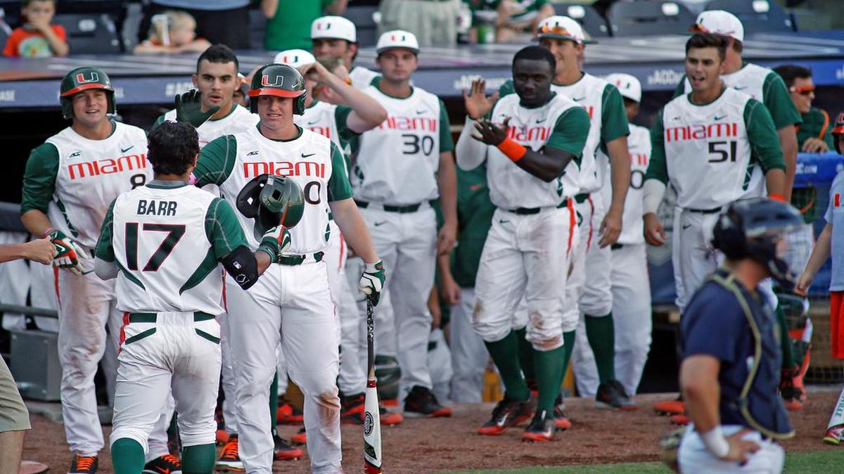 
Miami's Christopher Barr (17) is congratulated on his home run by teammates during the ninth inning of an NCAA college ACC tournament baseball game against Notre Dame in Durham, N.C., Saturday, May 23, 2015. Miami won 6-5. 
