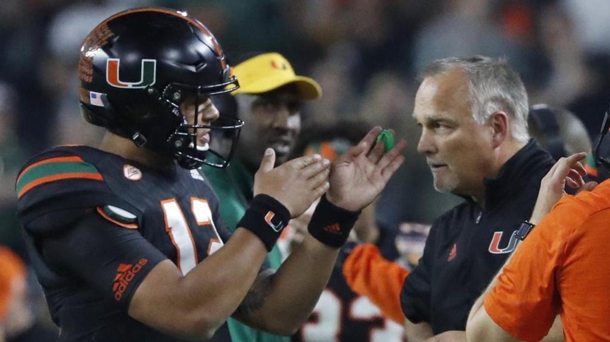 Miami Hurricanes quarterback Malik Rosier talks with head coach Mark Richt as the University of Miami takes on Wisconsin in the Capital One Orange Bowl game at Hard Rock Stadium on Saturday, December 30, 2017.