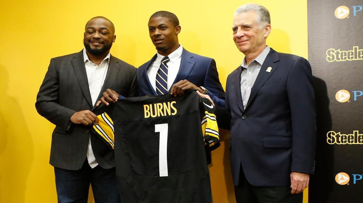 Artie Burns, center, a cornerback from Miami, poses for a photo with Pittsburgh Steelers coach Mike Tomlin, left, and President Arthur J. Rooney II as he holds a team jersey with his name on it after a news conference where he was introduced as the first round pick of the team and 25th overall in the NFL 2016 football draft, Friday, April 29, 2016 in Pittsburgh.