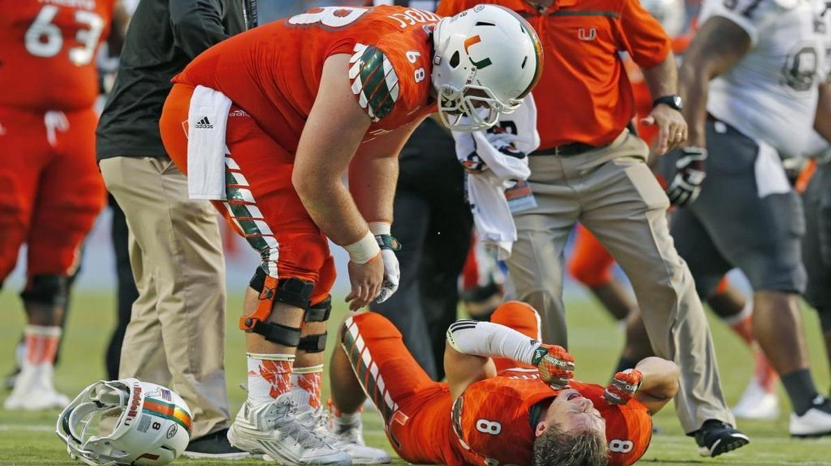 Miami Hurricanes wide receiver Braxton Berrios (8) grimaces in pain after going down in the first quarter as the University of Miami hosts Bethune-Cookman at Sun Life Stadium on Saturday, Sept. 5, 2015.