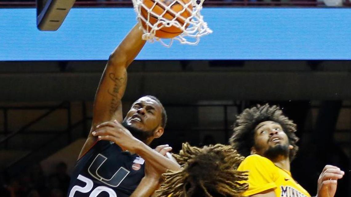 Miami's Dewan Huell, left, lays up as he gets tangled up with Minnesota’s Reggie Lynch, center, as Jordan Murphy looks on in the first half of an NCAA college basketball game Wednesday, Nov. 29, 2017, in Minneapolis.