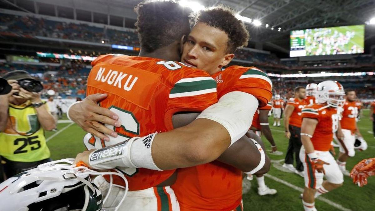 Miami Hurricanes tight end David Njoku (86) hugs quarterback Brad Kaaya (15) after the University of Miami defeats Duke at Hard Rock Stadium in Miami Gardens on Sat., Nov. 26, 2016