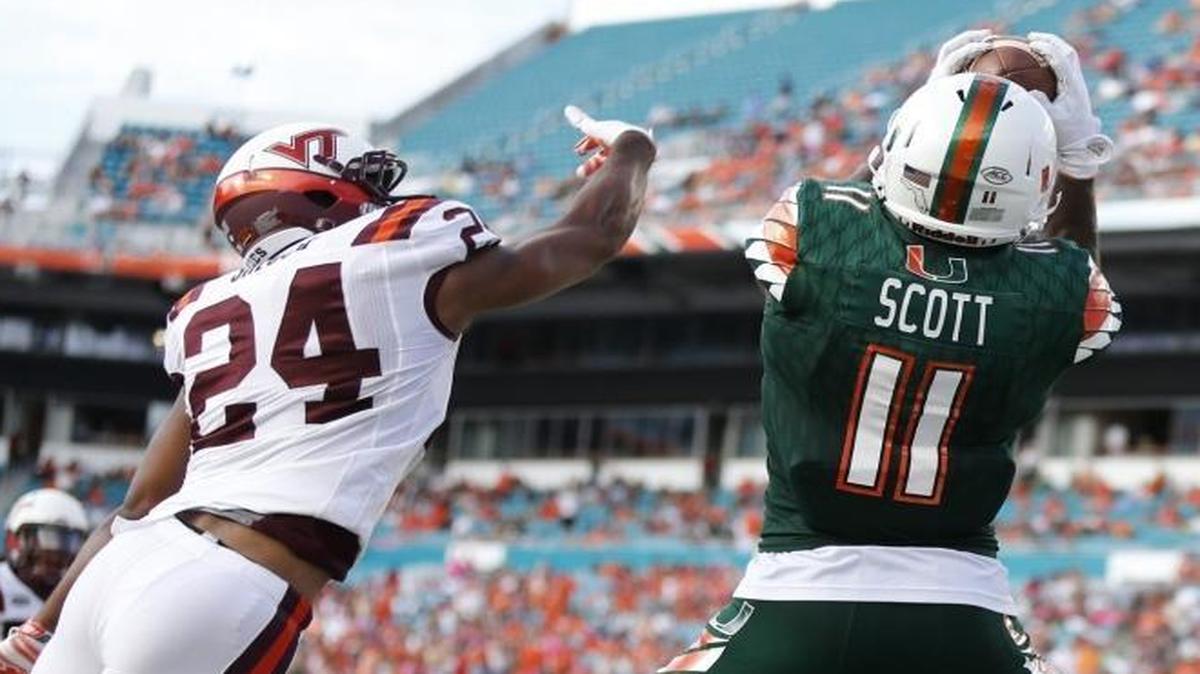 
UM wide receiver Rashawn Scott (11) scores in the second quarter as Virginia Tech’s Anthony Shegog (24) fails to make a stop as the University of Miami hosts Virginia Tech at Sun Life Stadium on Saturday, October 17, 2015.
