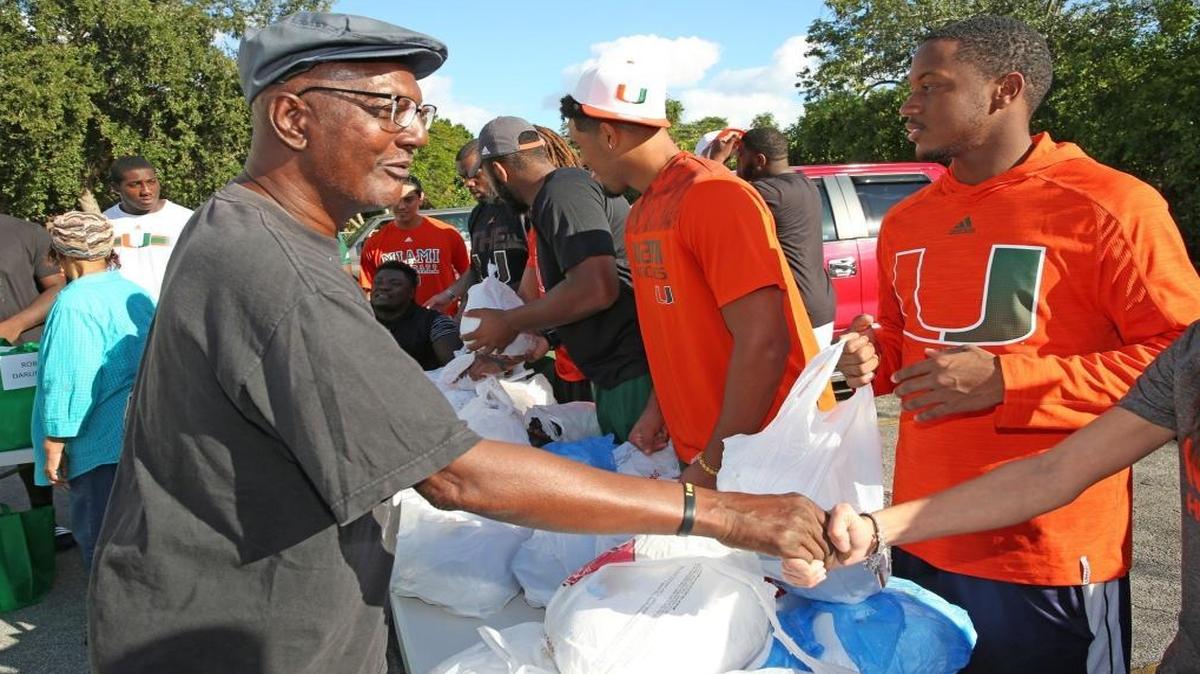Randy Brown, 63, thanks the University of Miami Football student athletes that handed out Thanksgiving meals to churchgoers from New Providence Missionary Baptist Church located on 760 NW 53rd Court in Miami on Tues., Nov. 22, 2016.