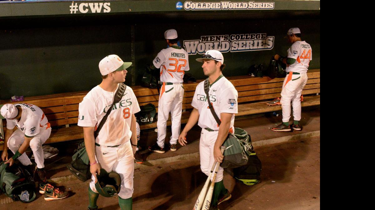 
Miami players leave the dugout after a 10-2 loss to Florida in an NCAA College World Series baseball elimination game in Omaha, Neb., Wednesday, June 17, 2015. 
