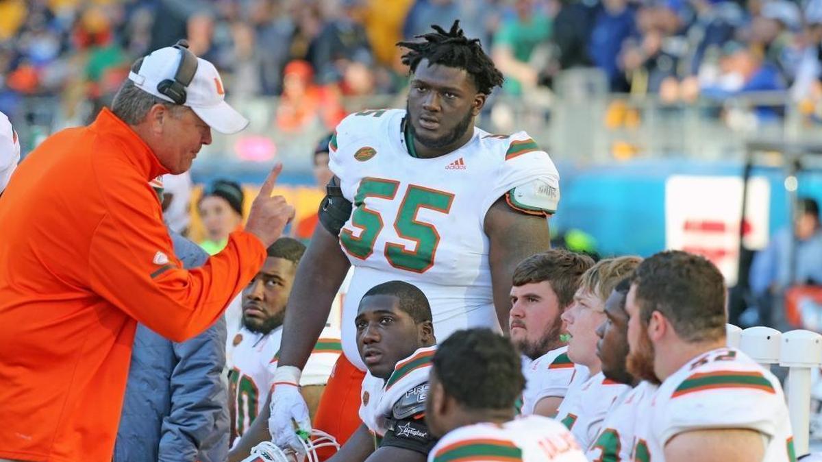 The Miami Hurricanes offensive linemen listen to offensive line coach Stacy Searels during UM’s final regular-season game at Pittsburgh on Nov. 24, 2017.