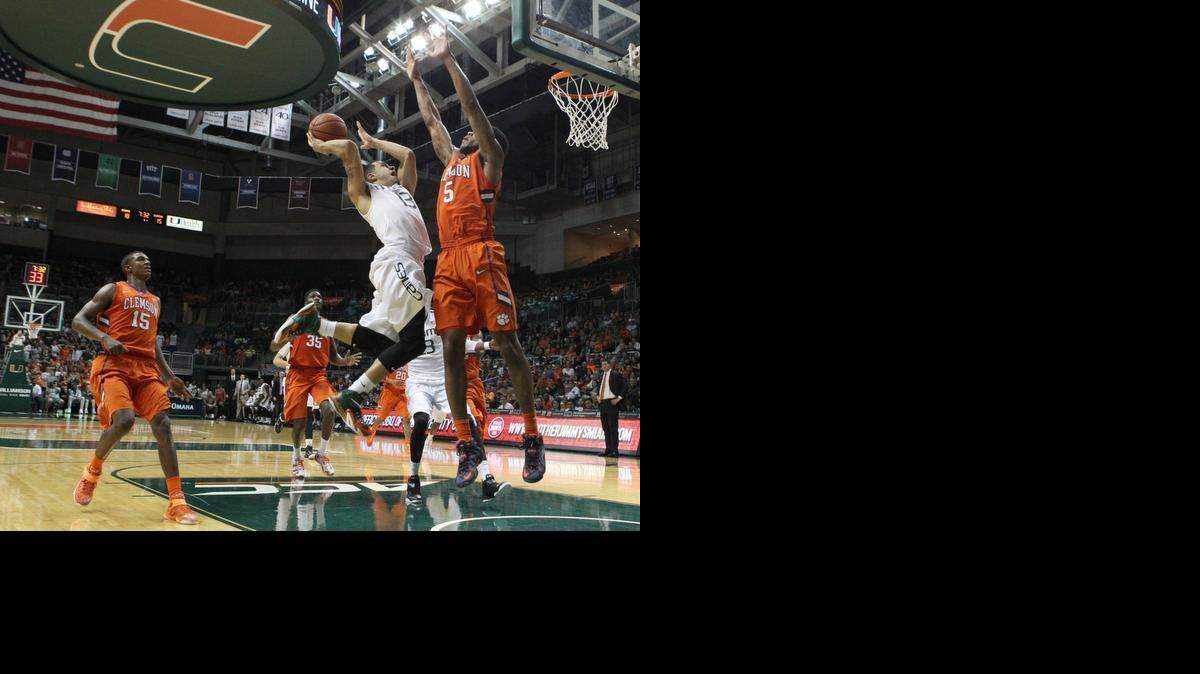 
MIami Hurricanes Angel Rodriguez goes in a lay up to thebasket against the defense of Clemson University Jaron Blosomgame in the first half during the game University of Miami vs Clemson University at the Bank United Center in Coral Gables, Sunday February 8, 2015.
