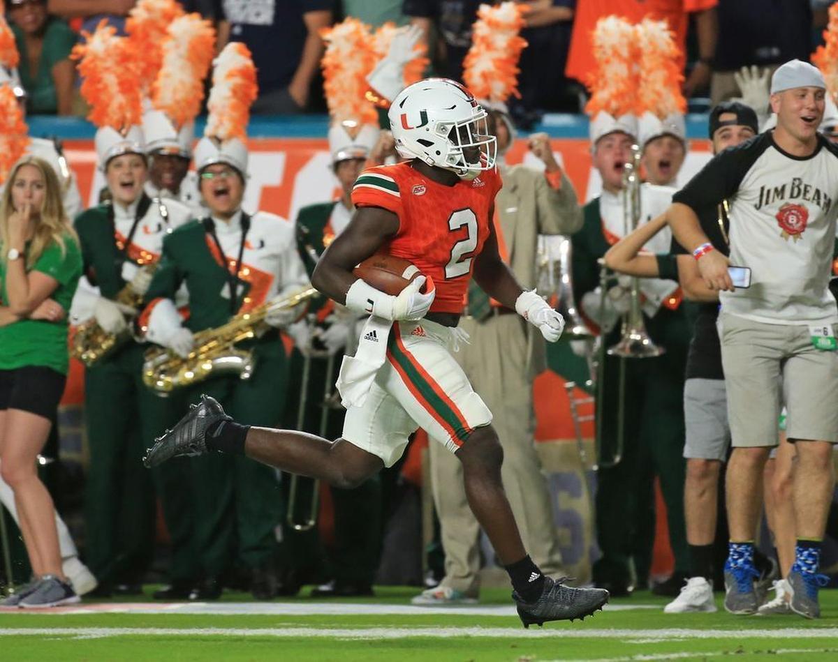 Miami Hurricanes defensive back Trajan Bandy (2) scores on an interception in the second quarter as the University of Miami Hurricanes host Notre Dame Fighting Irish at Hard Rock Stadium on Saturday, Nov. 11, 2017.
