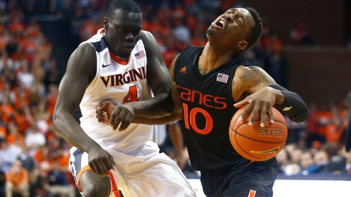 Virginia guard Marial Shayok (4) fouls Miami guard Sheldon McClellan (10) during the first half of an NCAA college basketball game in Charlottesville, Va., Tuesday, Jan. 12, 2016.