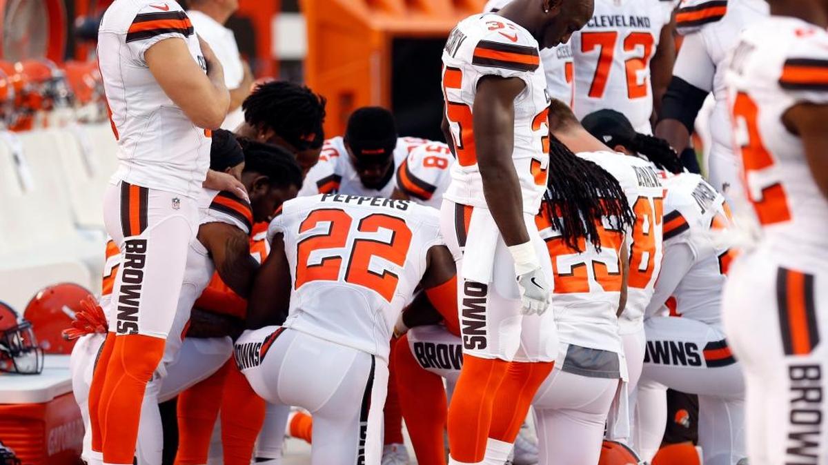 Members of the Cleveland Browns kneel in prayer during the national anthem before an NFL preseason football game between the New York Giants and the Cleveland Browns, Monday, Aug. 21, 2017, in Cleveland.
