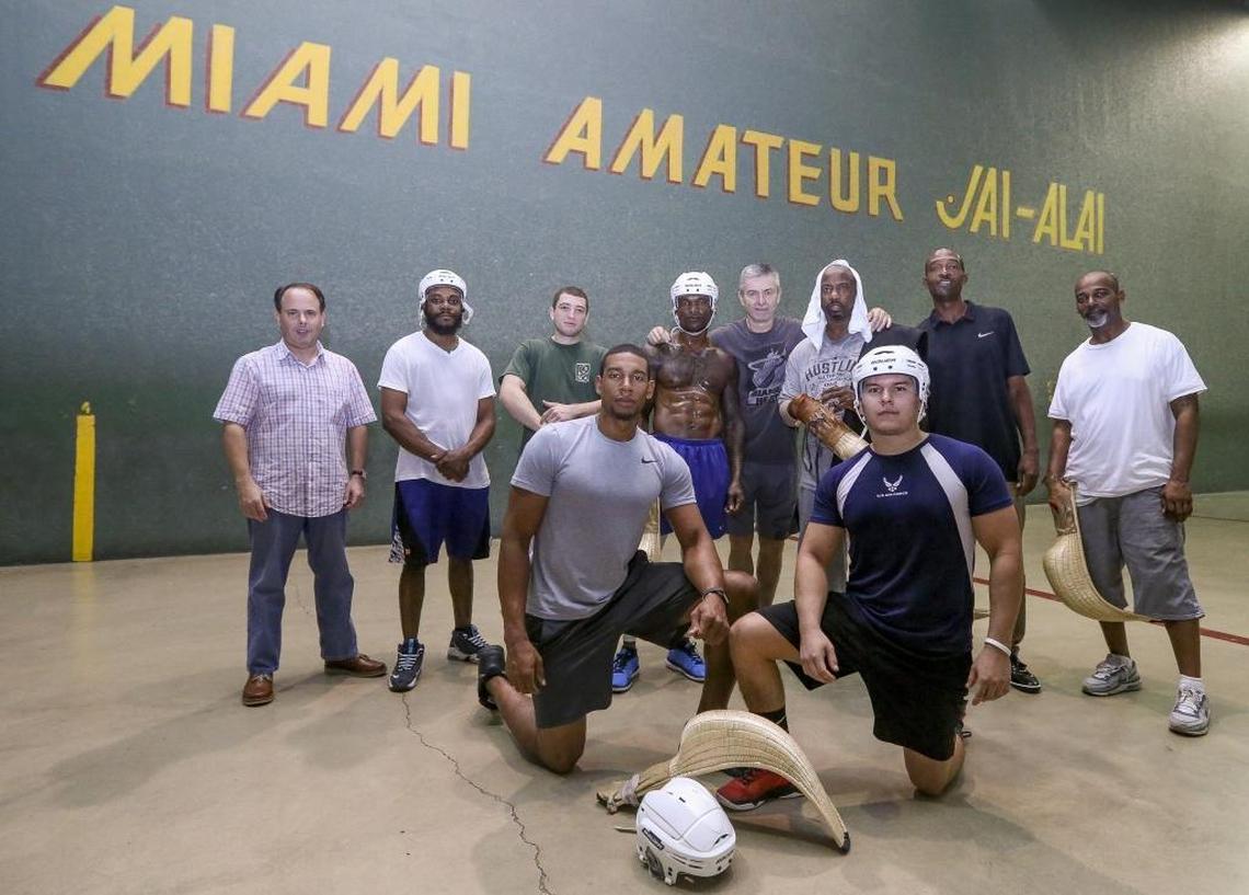 Former Miami jai-alai legend from the 1980s, Juan Ramon Arrasate, center, poses for a photo with University of Miami alumni and players during training at American Amateur Jai-Alai on Thursday, Feb. 8, 2018.