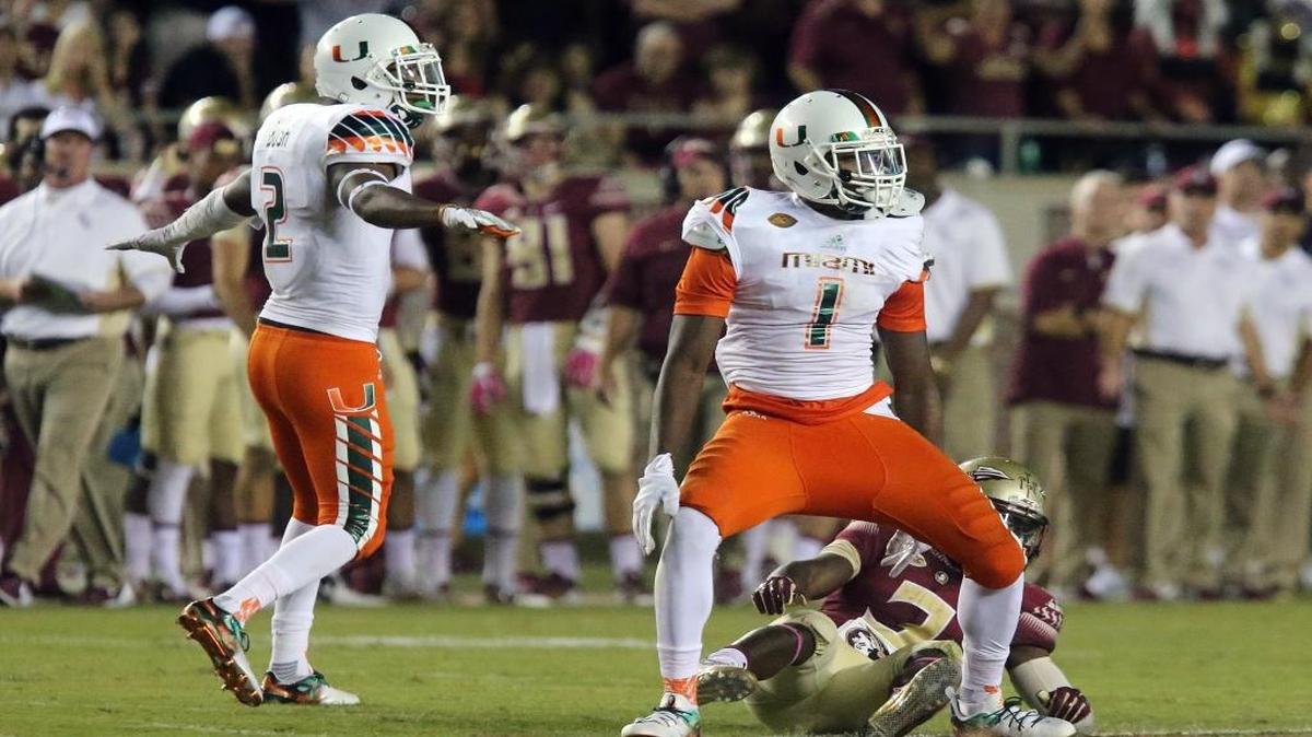 Miami's Devon Bush, left, and Artie Burns celebrate breaking up a pass intended for Florida State's Jesus Wilson during an NCAA college football game, Saturday, Oct. 10, 2015 in Tallahassee, Fla. Florida State won the game 29-24.