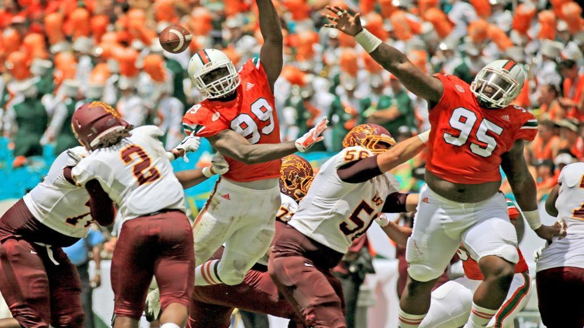 Miami Hurricanes defensive linemen Joe Jackson (99) and Anthony Moten (95) defend against the Bethune-Cookman Wildcats at Hard Rock Stadium on Saturday, September 2, 2017.