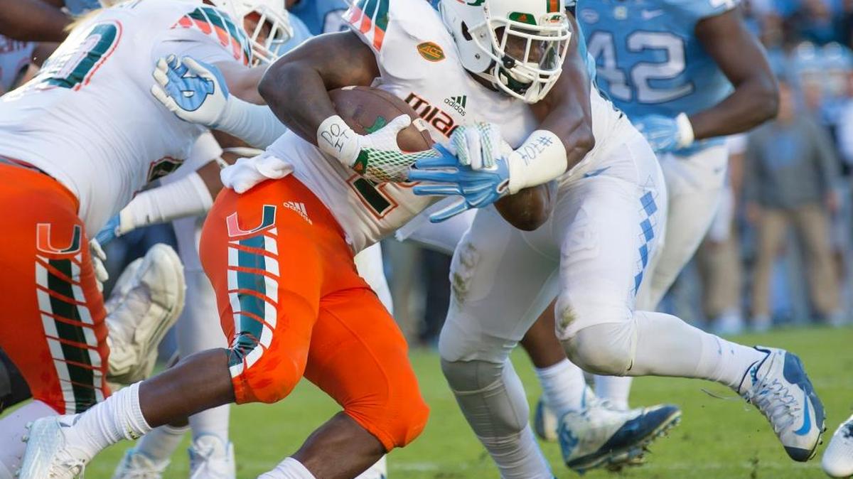 UM’s Joe Yearby fights for a short gain against North Carolina in Chapel Hill, N.C., Saturday, Nov. 14, 2015.