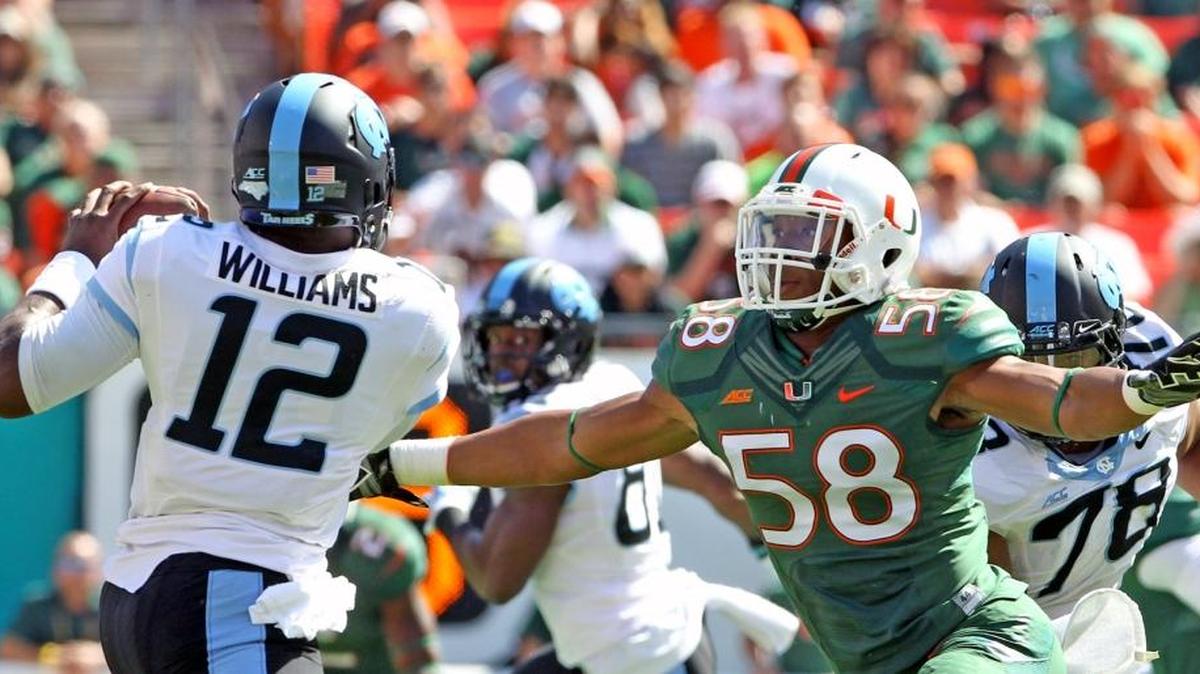 
Miami Hurricanes linebacker Darrion Ownens chases down North Carolina Tar Heels quarterback Marquise Williams in the fourth quarter of their game at Sun Life Stadium in Miami Gardens on Nov. 1, 2014.

